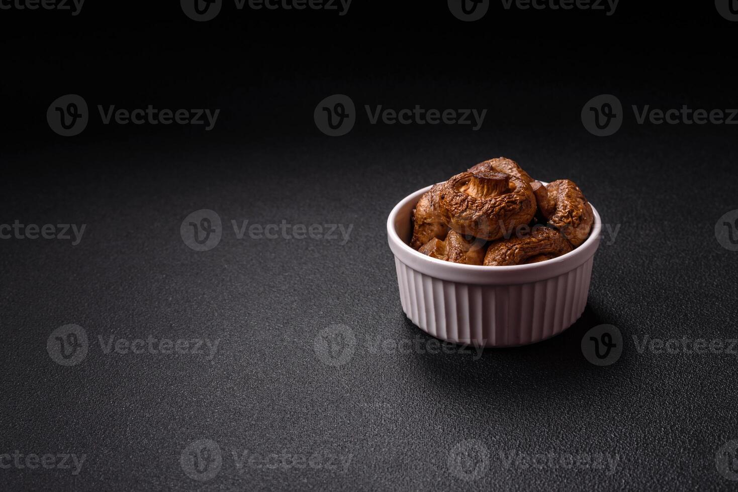 Delicious juicy whole champignons baked on the grill with salt and spices photo