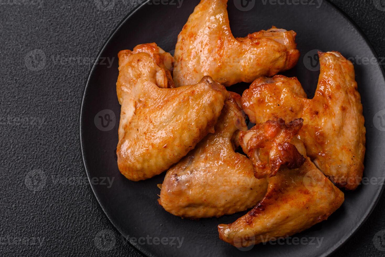Delicious fried chicken wings with salt, spices and herbs photo