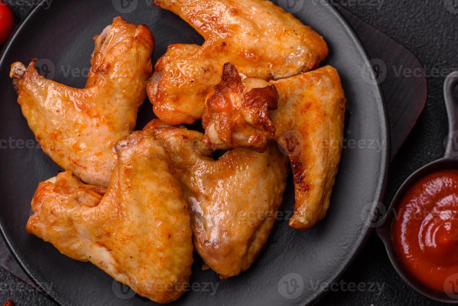 Delicious fried chicken wings with salt, spices and herbs photo