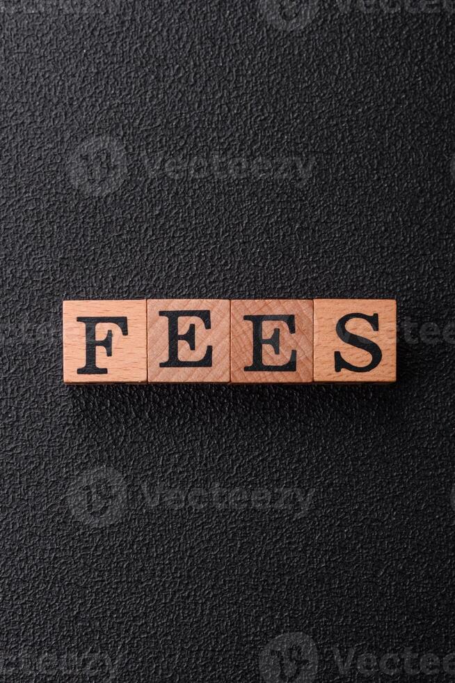 Inscription Fees with wooden cubes, conceptual background with copy space photo