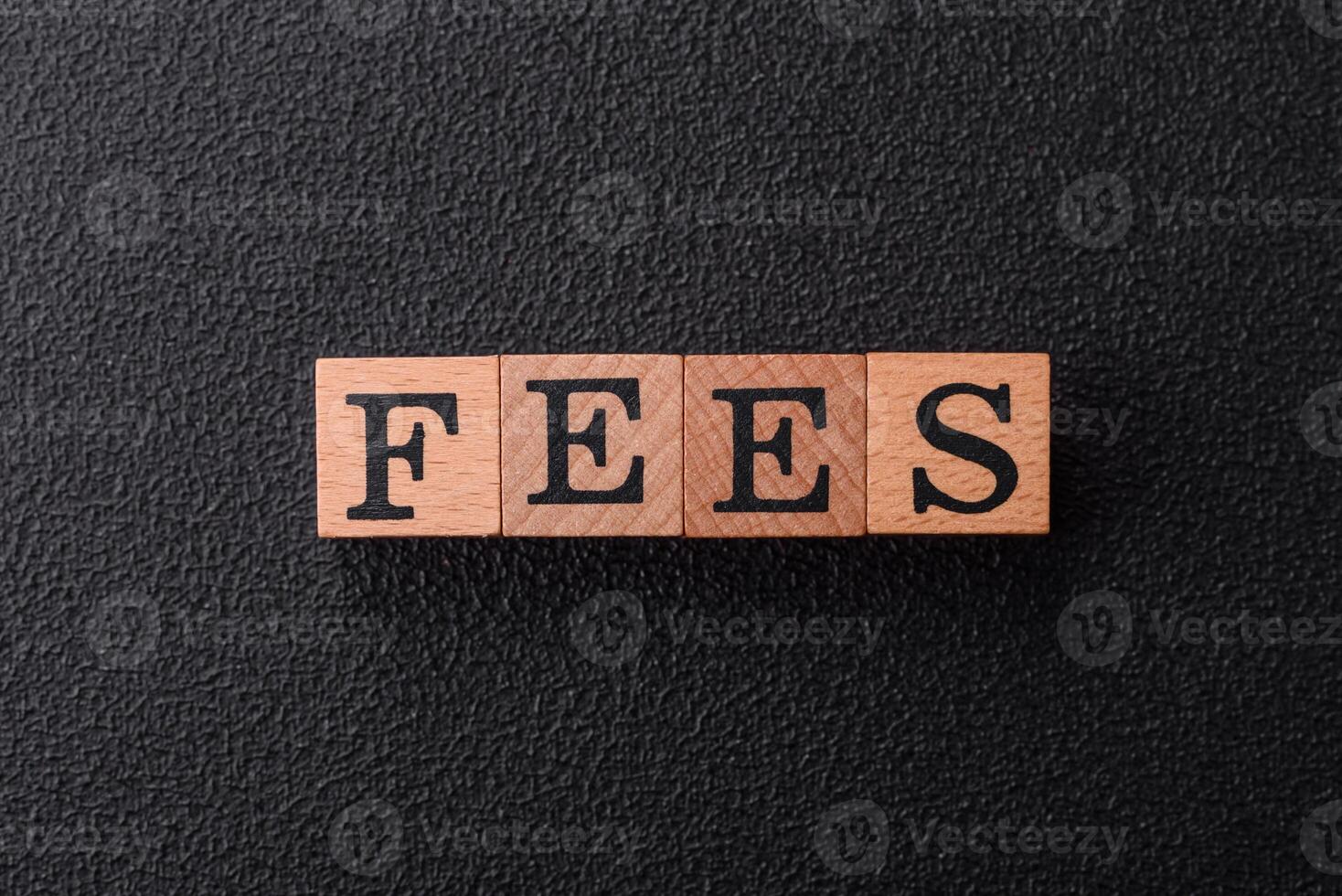 Inscription Fees with wooden cubes, conceptual background with copy space photo
