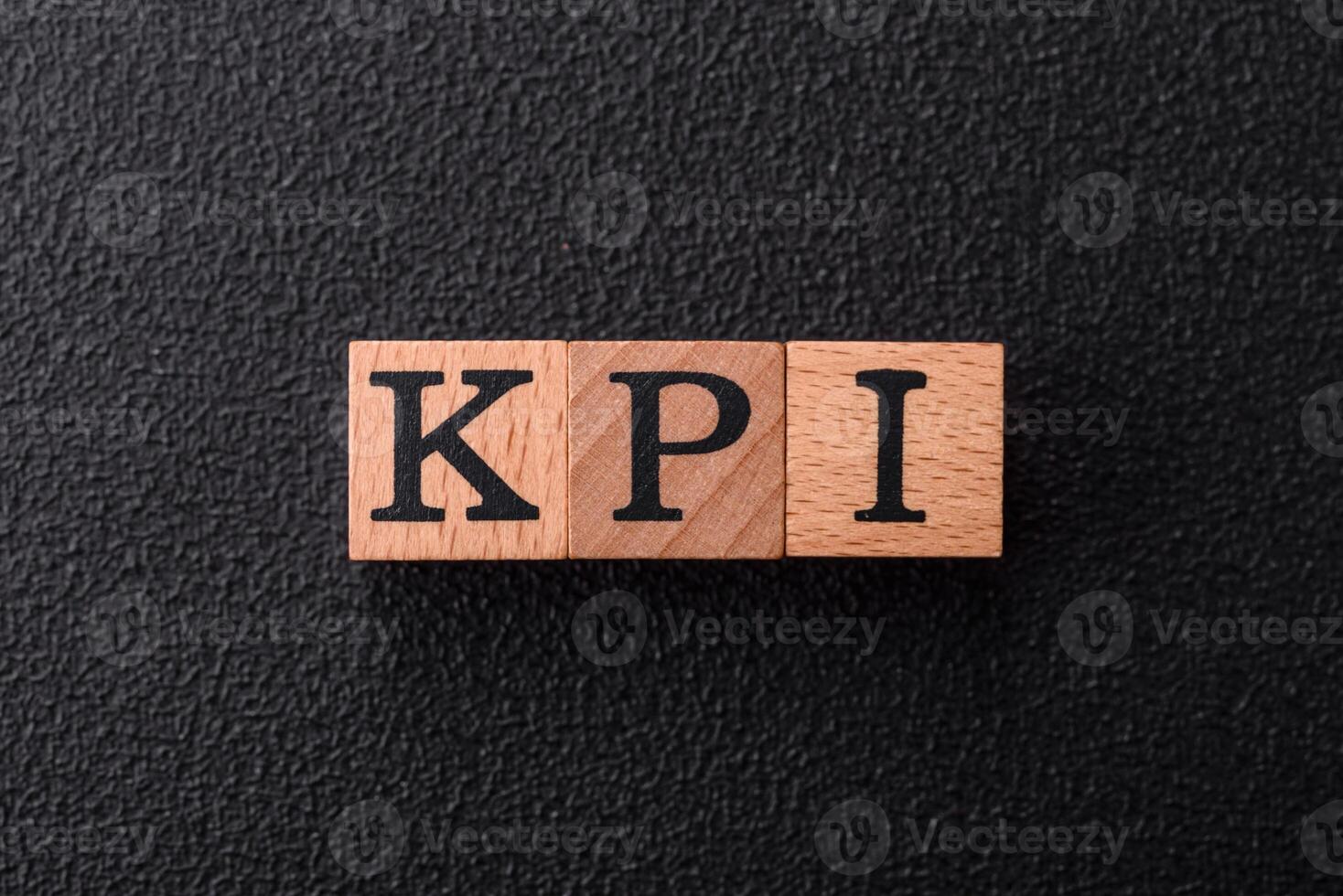 Inscription KPI Key Performance Indicator with wooden cubes photo