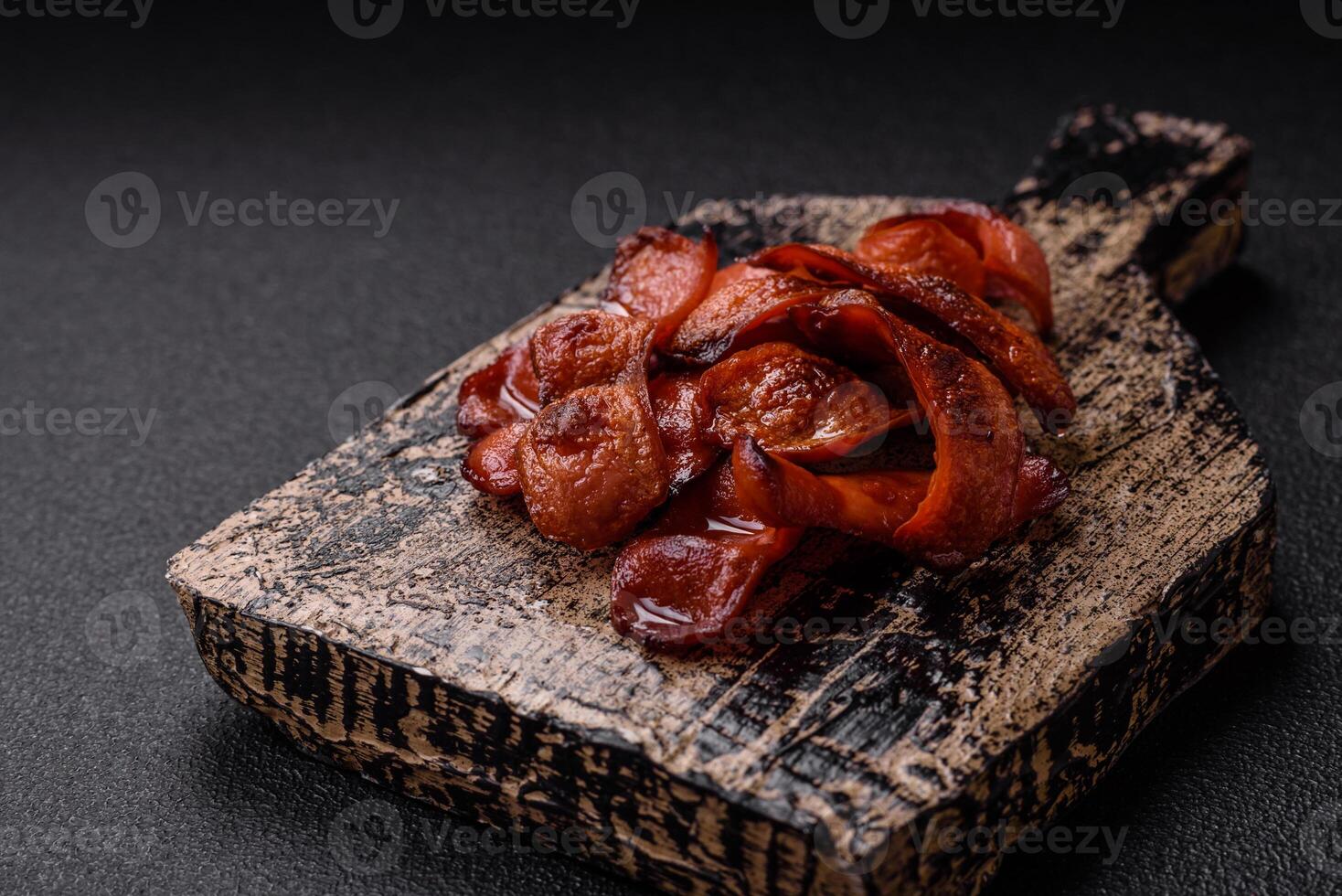 Fried sausages sliced with salt and spices as an ingredient for an English breakfast photo