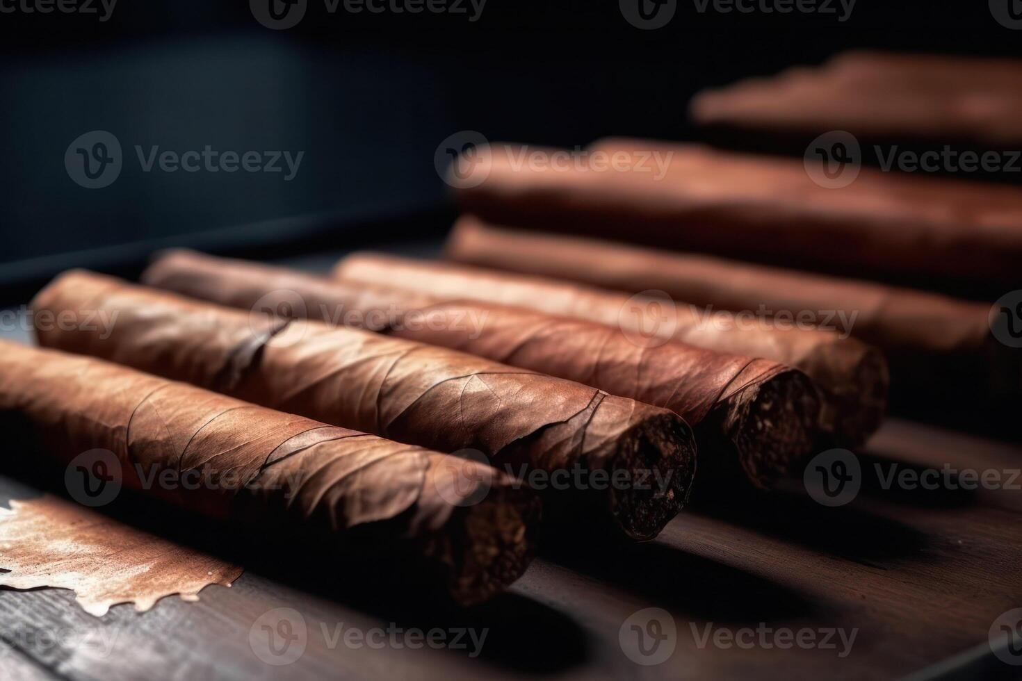 Artisan Cigar Collection. A close-up view of a row of handmade cigars on a dark backdrop, emphasizing their textured craftsmanship. Copy space. photo