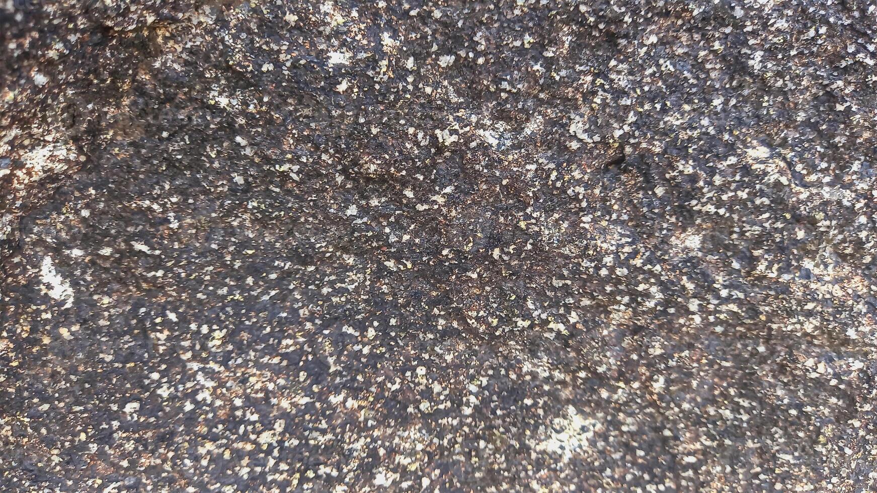 Rough, grey, dark harsh and high contrast granite stone texture background. A close-up of the surface of abstract natural rock. Natural Marble stone wallpaper. photo