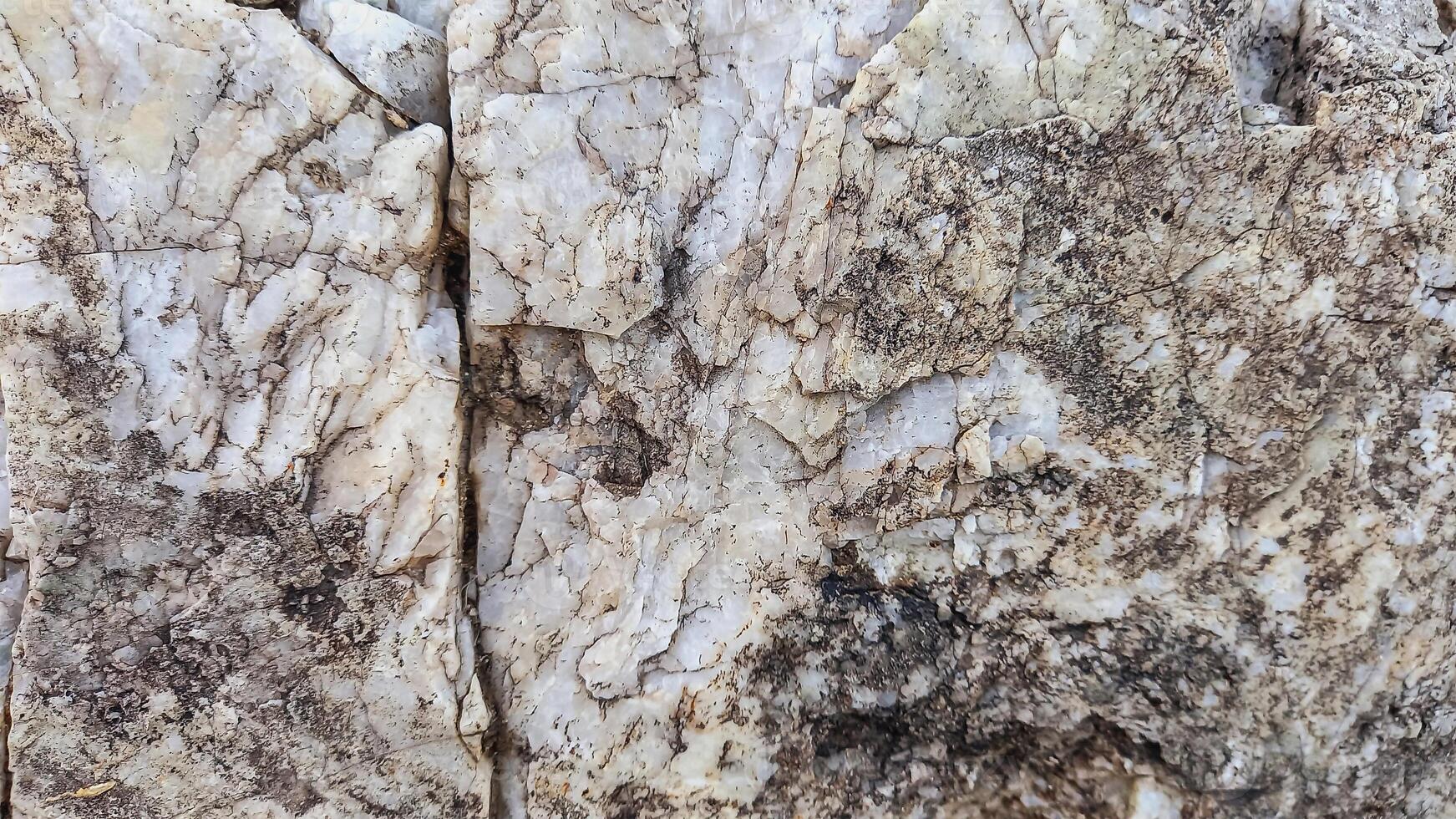 Rough, grey, dark harsh and high contrast granite stone texture background. A close-up of the surface of abstract natural rock. Natural Marble stone wallpaper. photo