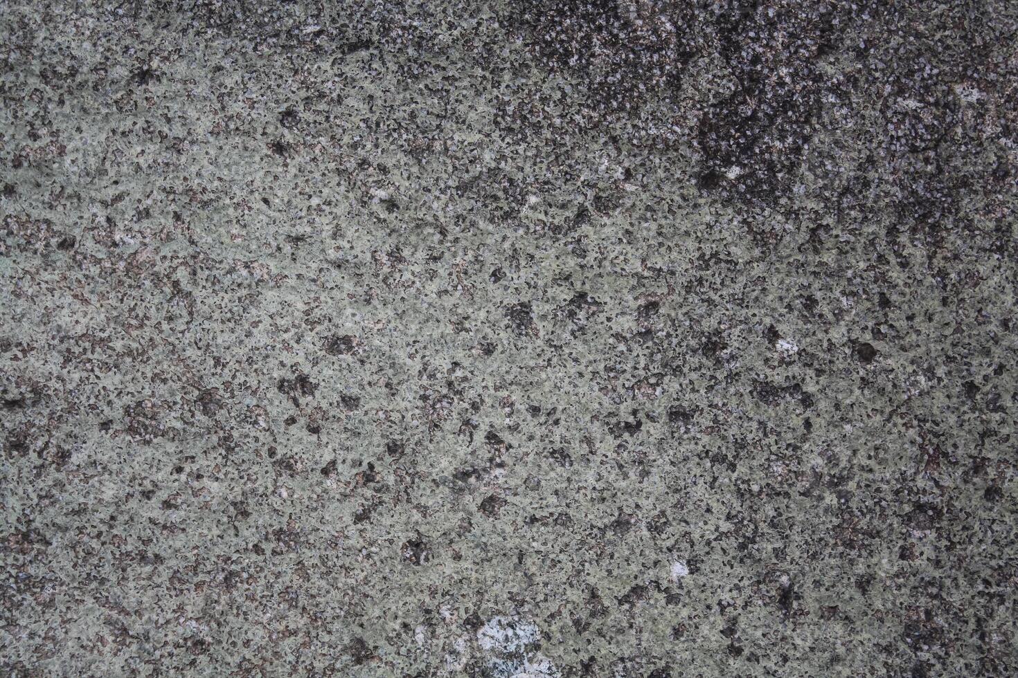 Rough, grey, dark harsh and high contrast granite stone texture background. A close-up of the surface of abstract natural rock. Natural Marble stone wallpaper. photo