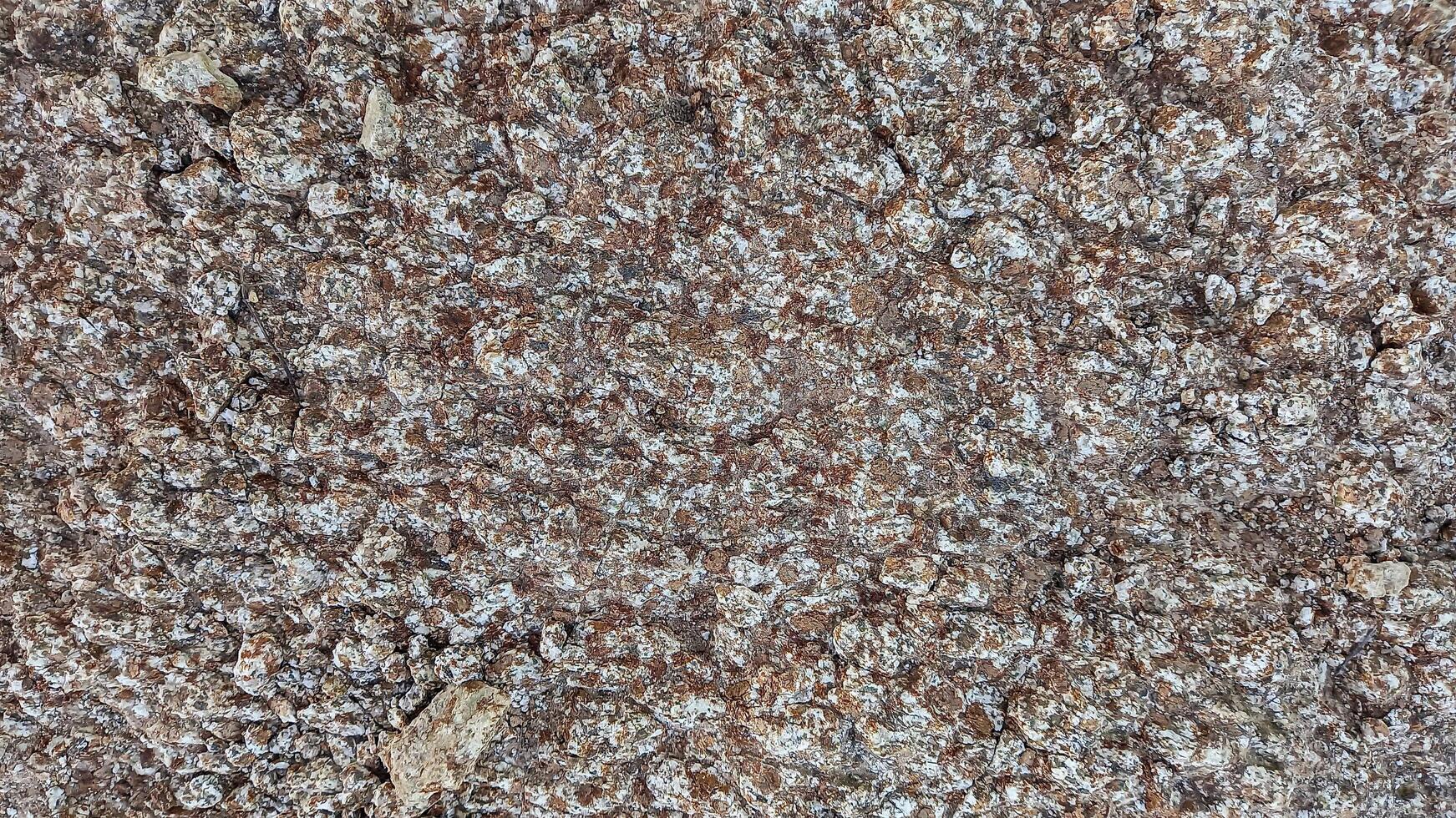 Rough, grey, dark harsh and high contrast granite stone texture background. A close-up of the surface of abstract natural rock. Natural Marble stone wallpaper. photo