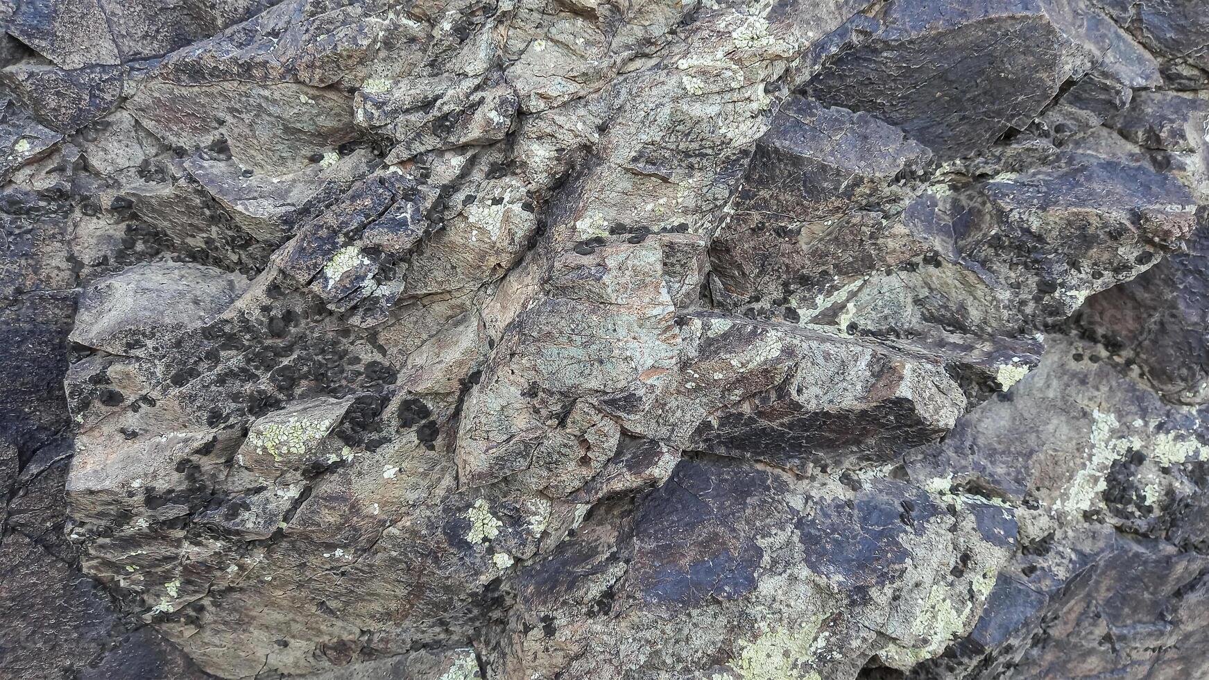 Rough, grey, dark harsh and high contrast granite stone texture background. A close-up of the surface of abstract natural rock. Natural Marble stone wallpaper. photo