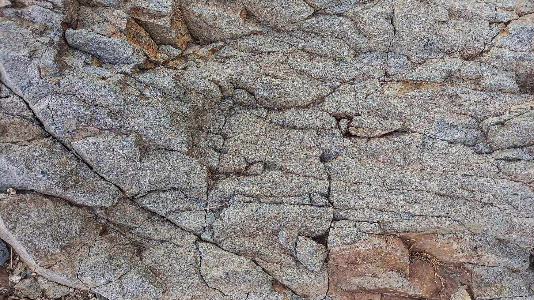 Rough, grey, dark harsh and high contrast granite stone texture background. A close-up of the surface of abstract natural rock. Natural Marble stone wallpaper. photo