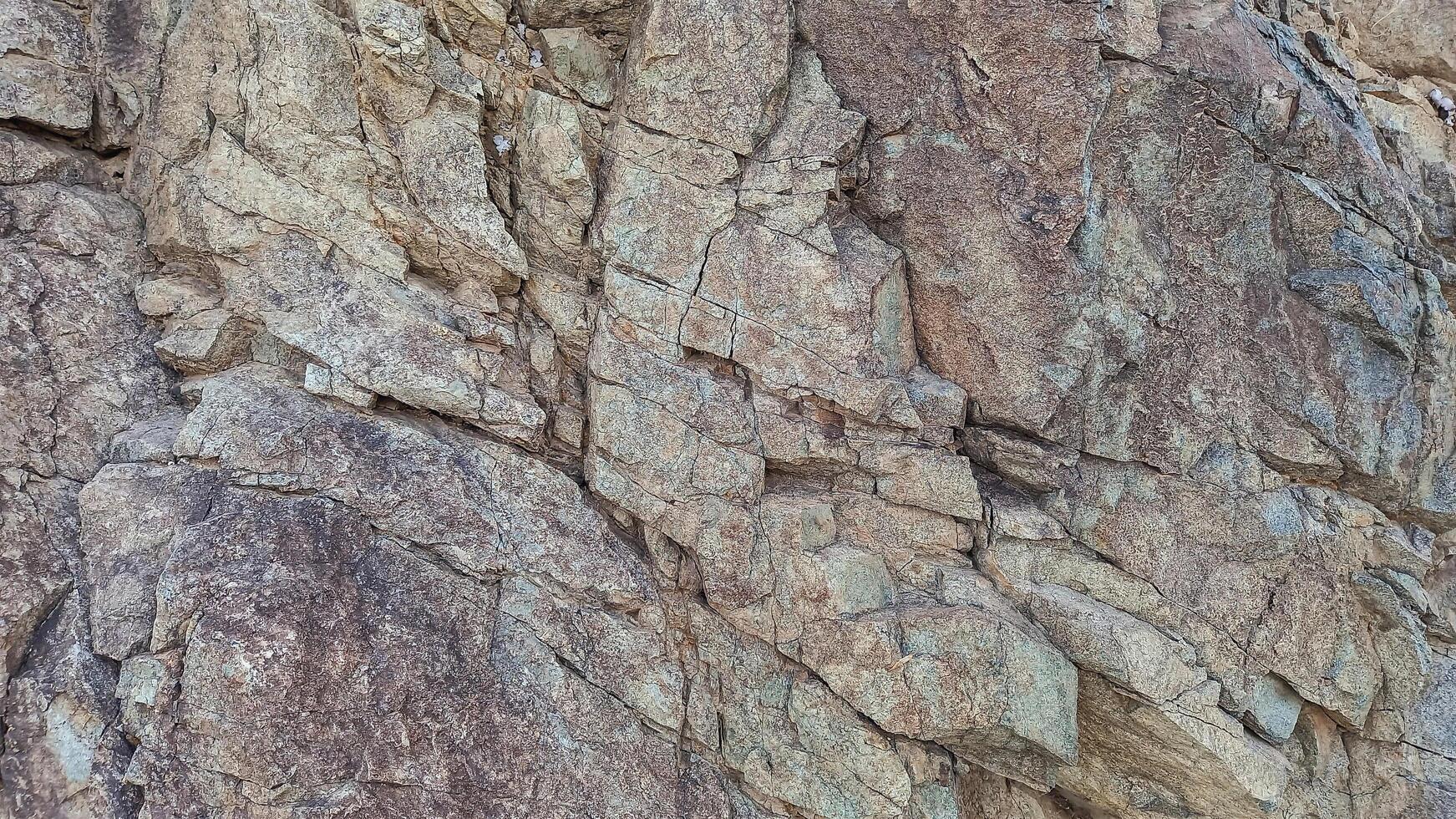 Rough, grey, dark harsh and high contrast granite stone texture background. A close-up of the surface of abstract natural rock. Natural Marble stone wallpaper. photo