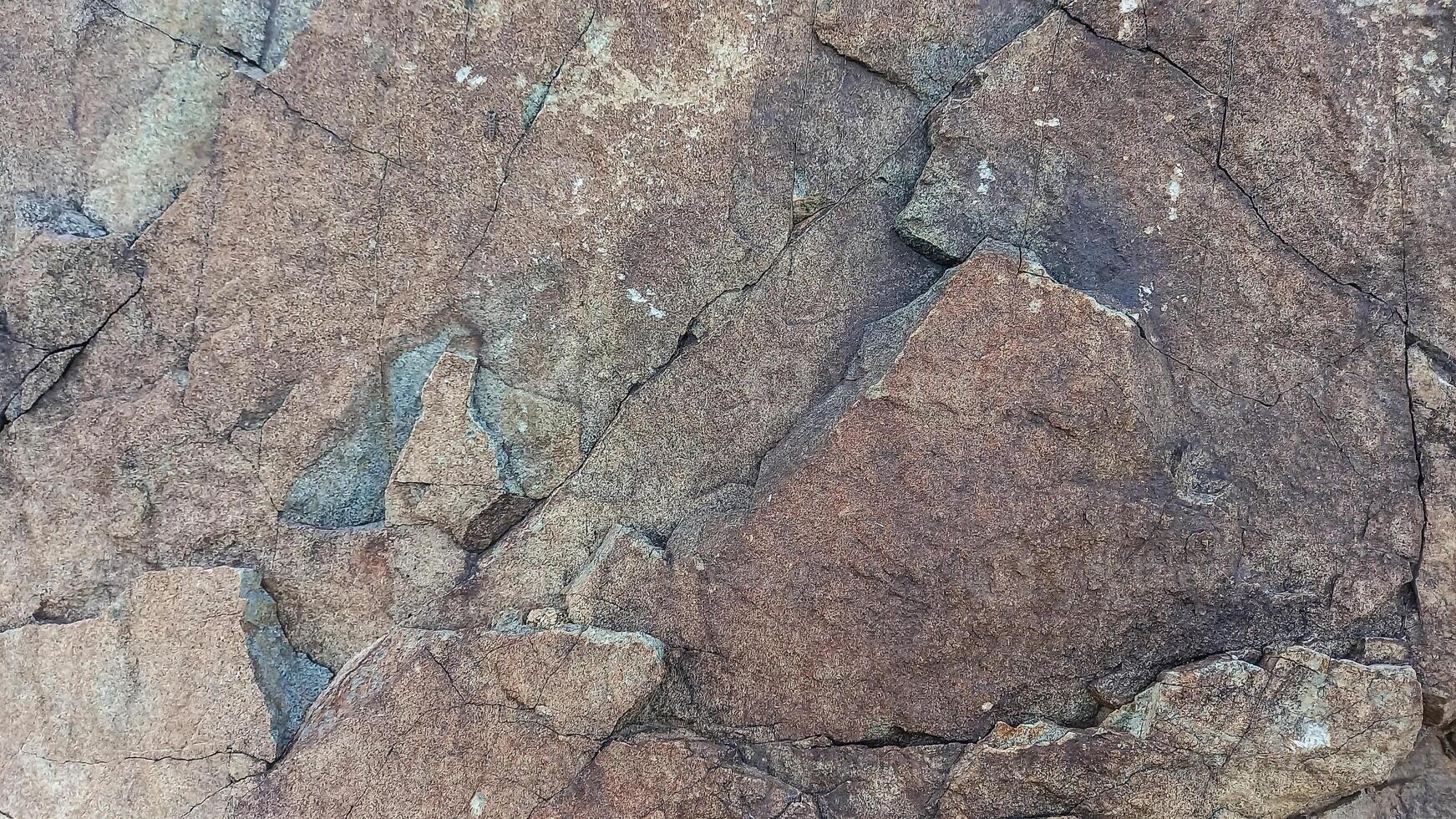 Rough, grey, dark harsh and high contrast granite stone texture background. A close-up of the surface of abstract natural rock. Natural Marble stone wallpaper. photo