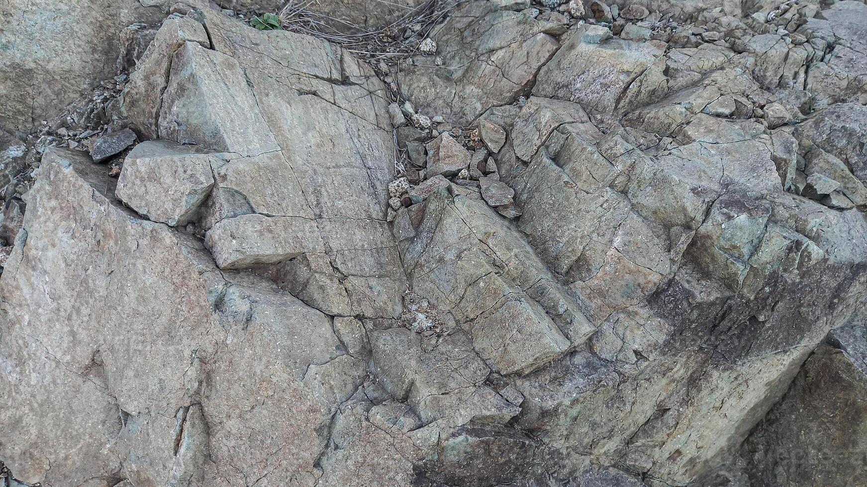 Rough, grey, dark harsh and high contrast granite stone texture background. A close-up of the surface of abstract natural rock. Natural Marble stone wallpaper. photo