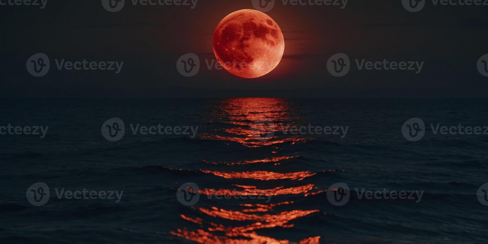 Harvest Moon - glowing bright red moon over the sea. photo
