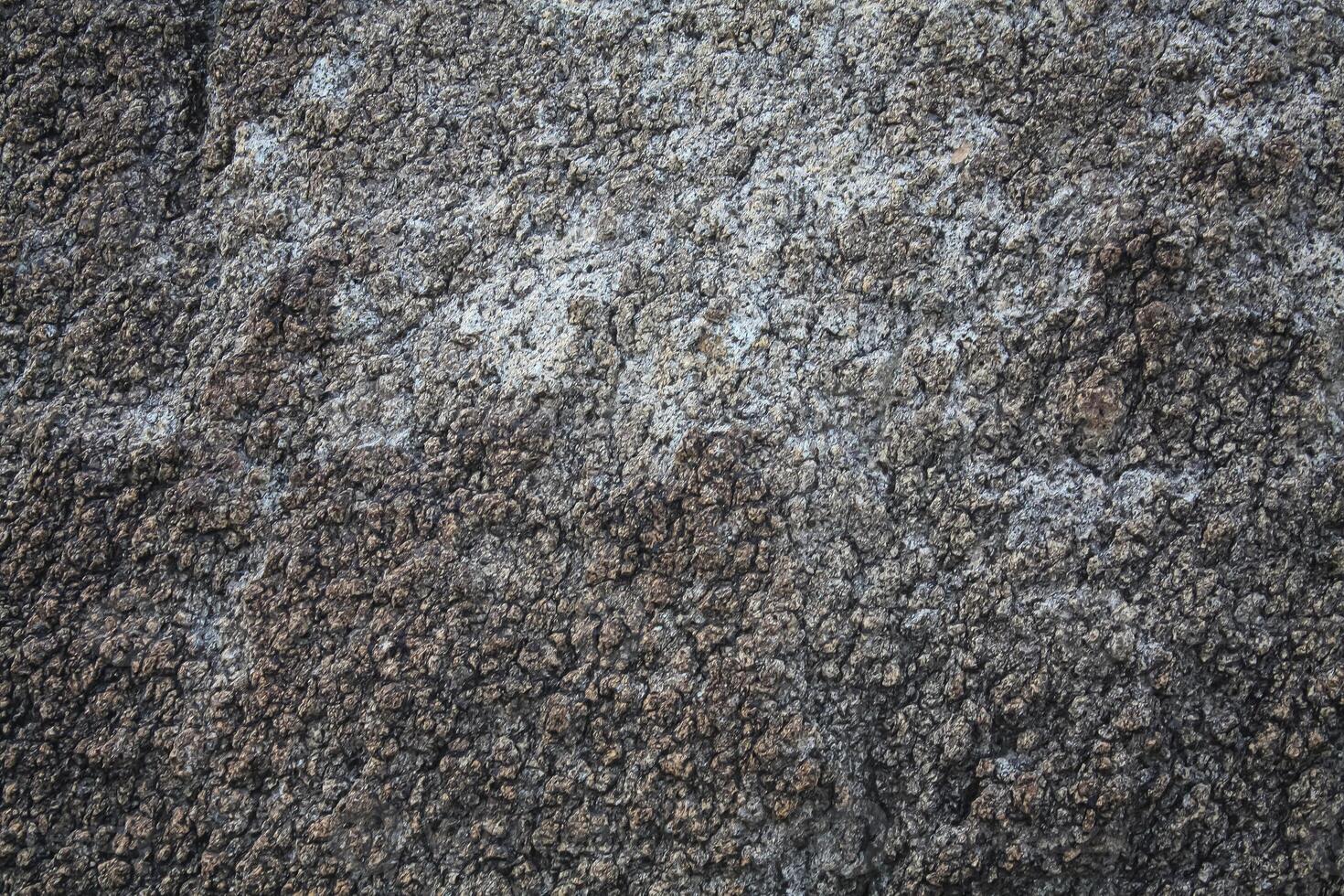 Rough, grey, dark harsh and high contrast granite stone texture background. A close-up of the surface of abstract natural rock. Natural Marble stone wallpaper. photo