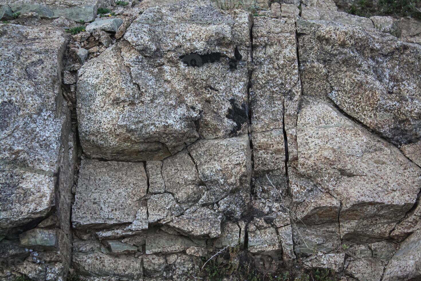 Rough, grey, dark harsh and high contrast granite stone texture background. A close-up of the surface of abstract natural rock. Natural Marble stone wallpaper. photo