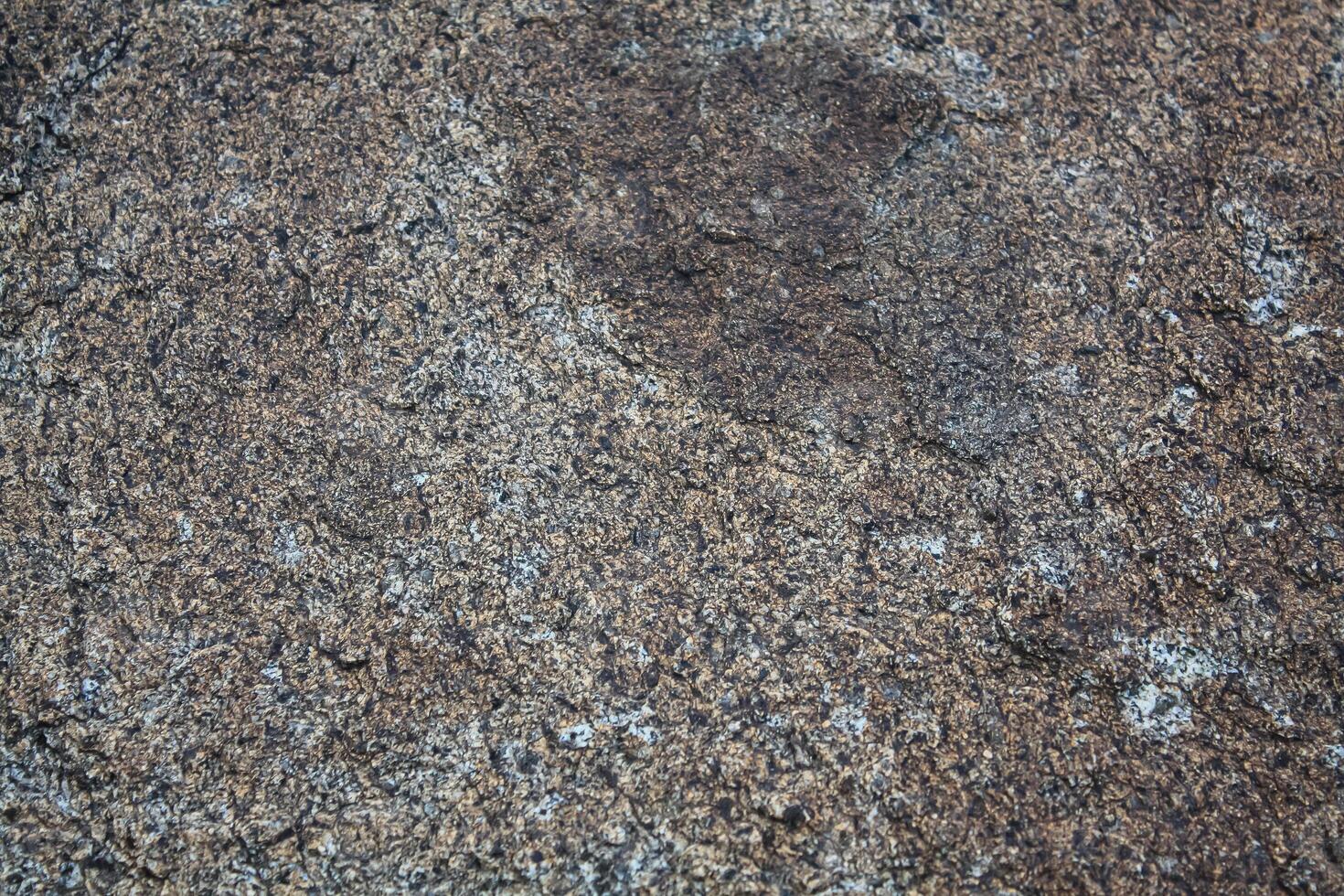 Rough, grey, dark harsh and high contrast granite stone texture background. A close-up of the surface of abstract natural rock. Natural Marble stone wallpaper. photo