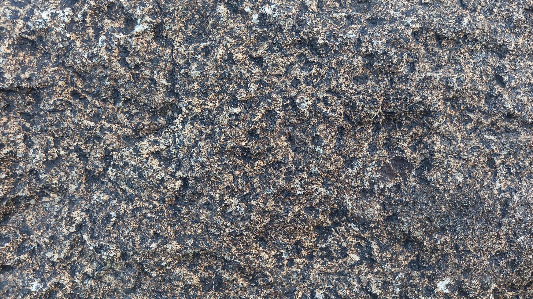 Rough, grey, dark harsh and high contrast granite stone texture background. A close-up of the surface of abstract natural rock. Natural Marble stone wallpaper. photo