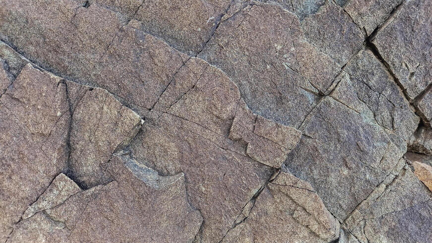Rough, grey, dark harsh and high contrast granite stone texture background. A close-up of the surface of abstract natural rock. Natural Marble stone wallpaper. photo