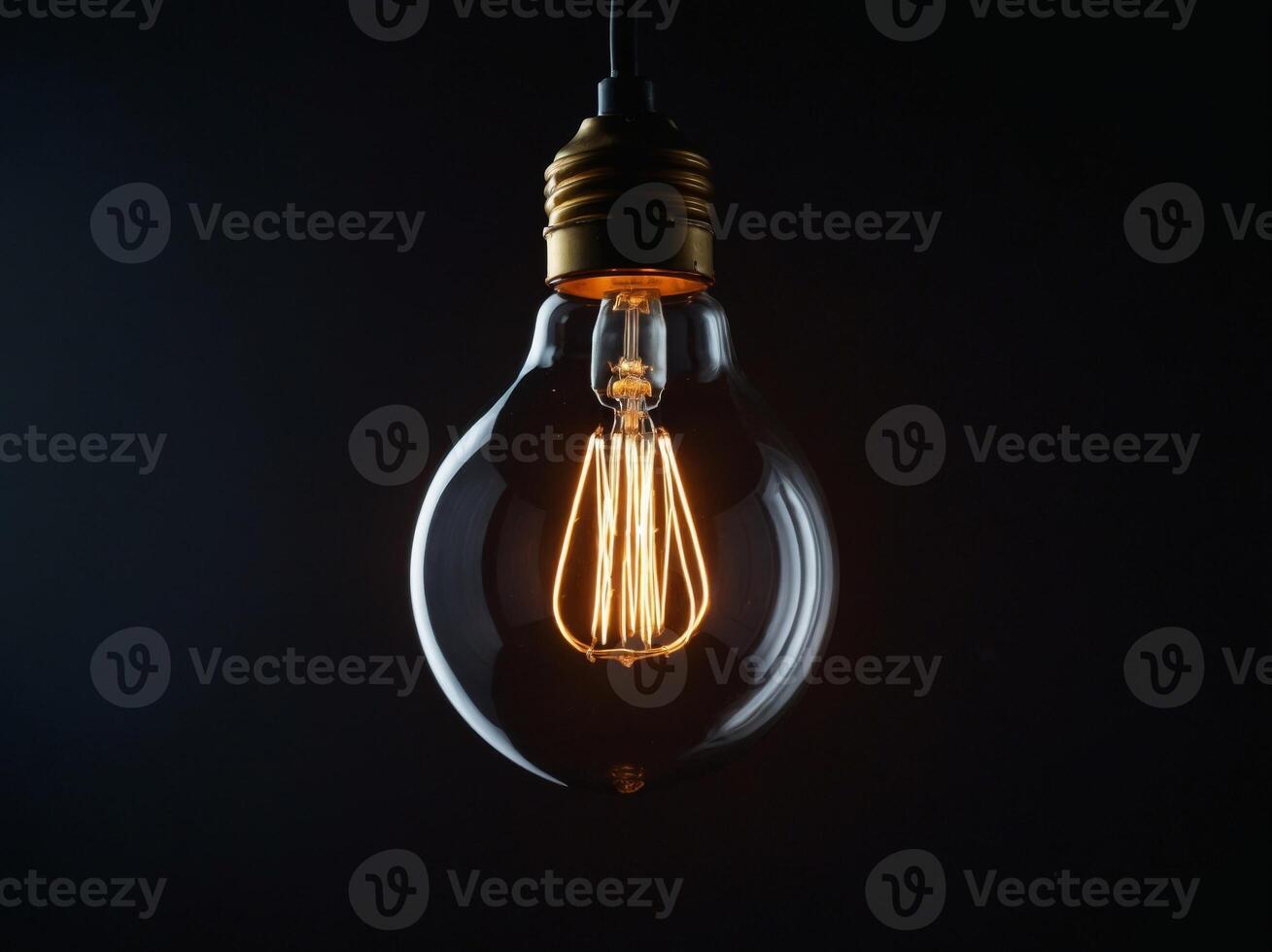 Luminous light bulb emphasizing electricity conservation on contrasting dark backdrop. photo