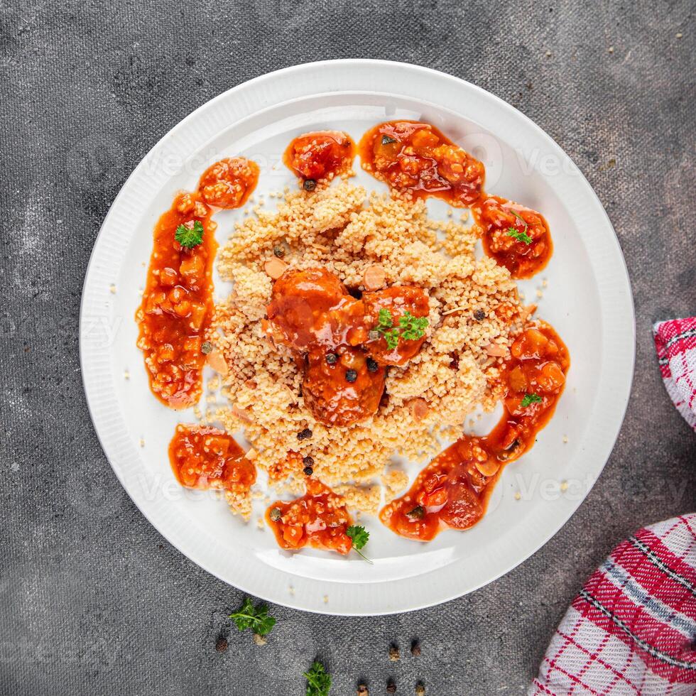 couscous with meat balls vegetable sauce tasty fresh meal food snack on the table copy space food background rustic top view keto or paleo diet photo