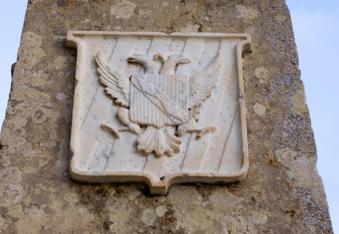 GOZO, MALTA - SEPTEMBER 14, 2012 medieval coats of arms of knights made of marble on the walls of the fortress on the island of Gozo, Malta photo