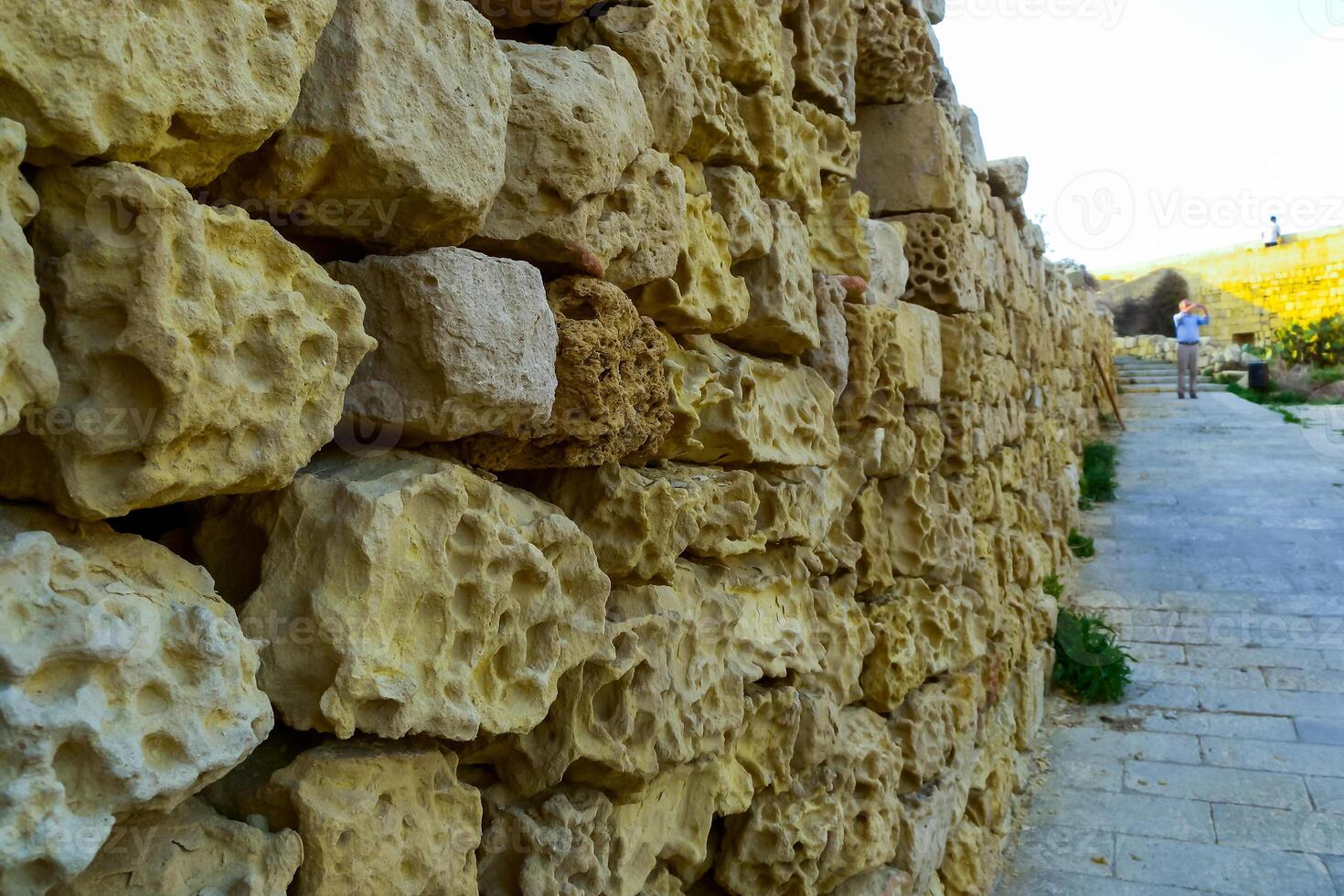 Weathering, erosion and destruction of limestone bricks of ancient structures on the island of Gozo, Malta photo