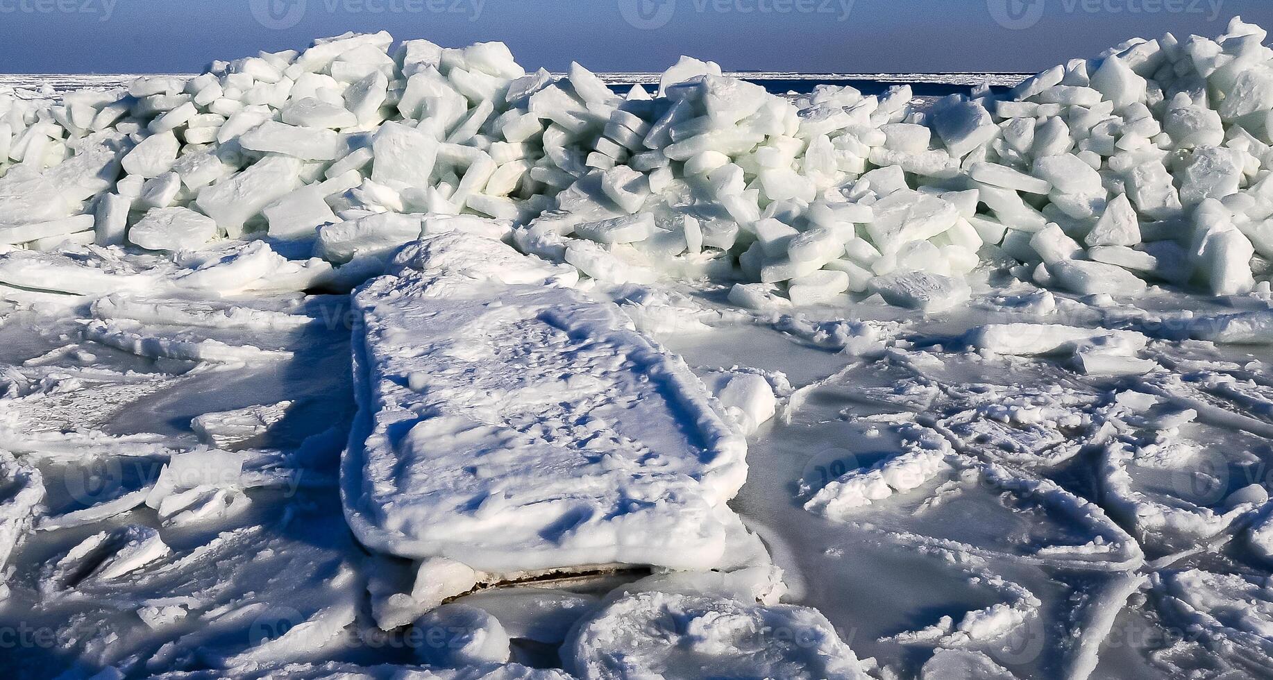Ice Climatic collapse, heaps of ice blocks on the piers and the shore. The Black Sea near Odessa is frozen photo