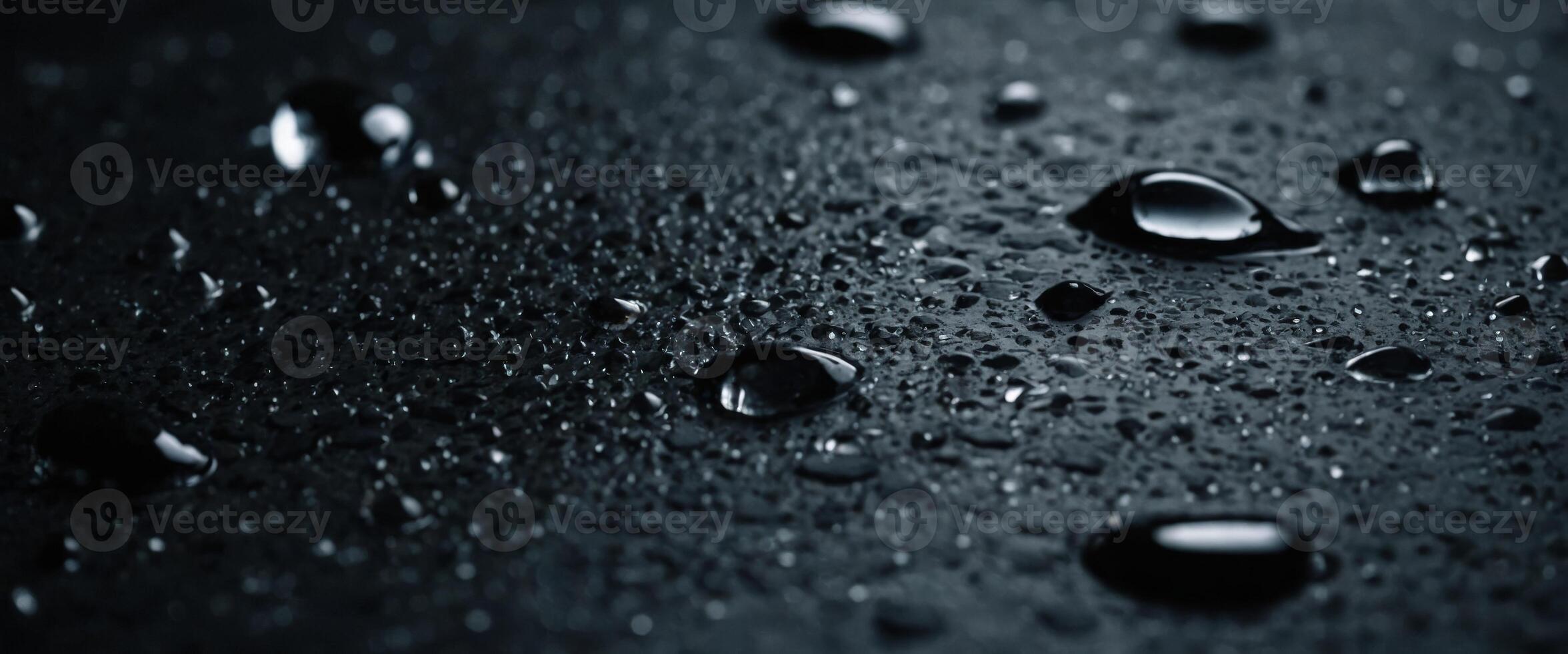 Water drops on dark stone surface of basalt or granite. photo