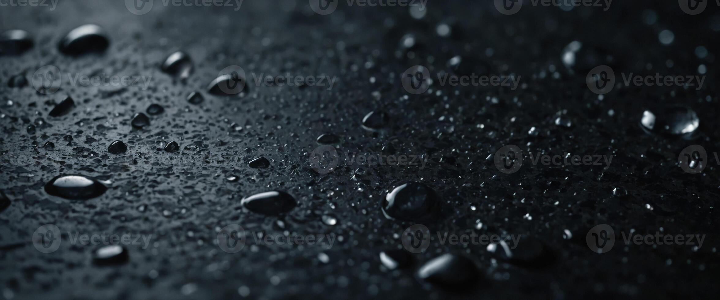 Water drops on dark stone surface of basalt or granite. photo