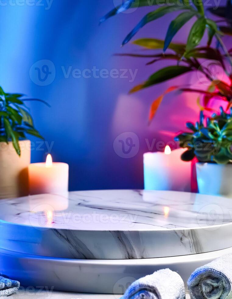 Marble Podium with Rolled Towels and Candles in Blue and Pink Lighting photo