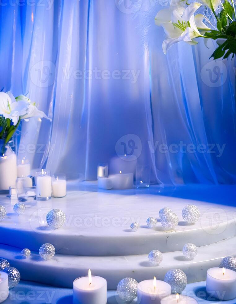 White candles and silver ornaments on a white marble podium photo
