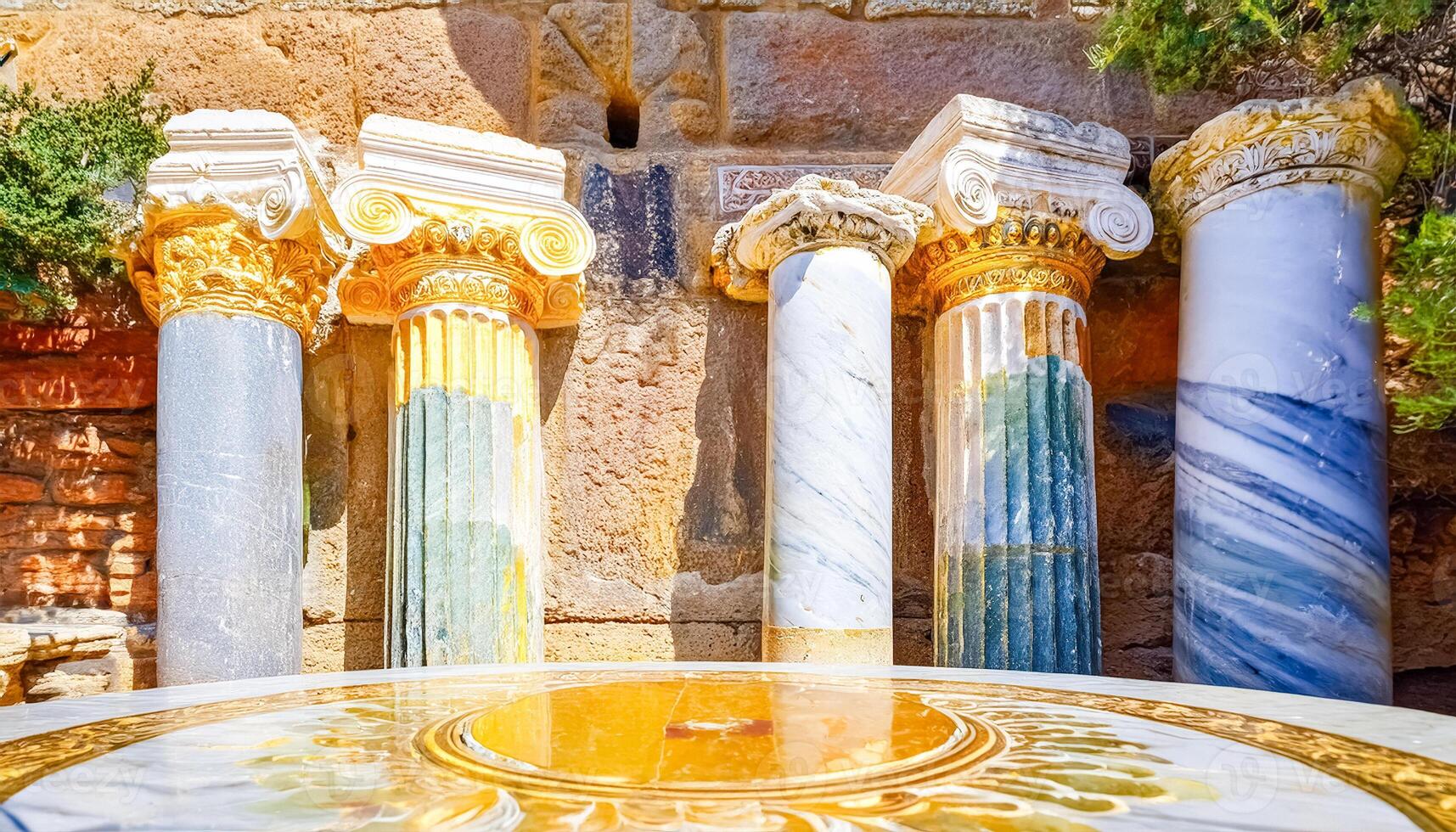 Ancient Roman Columns and a Golden Circular Pool photo