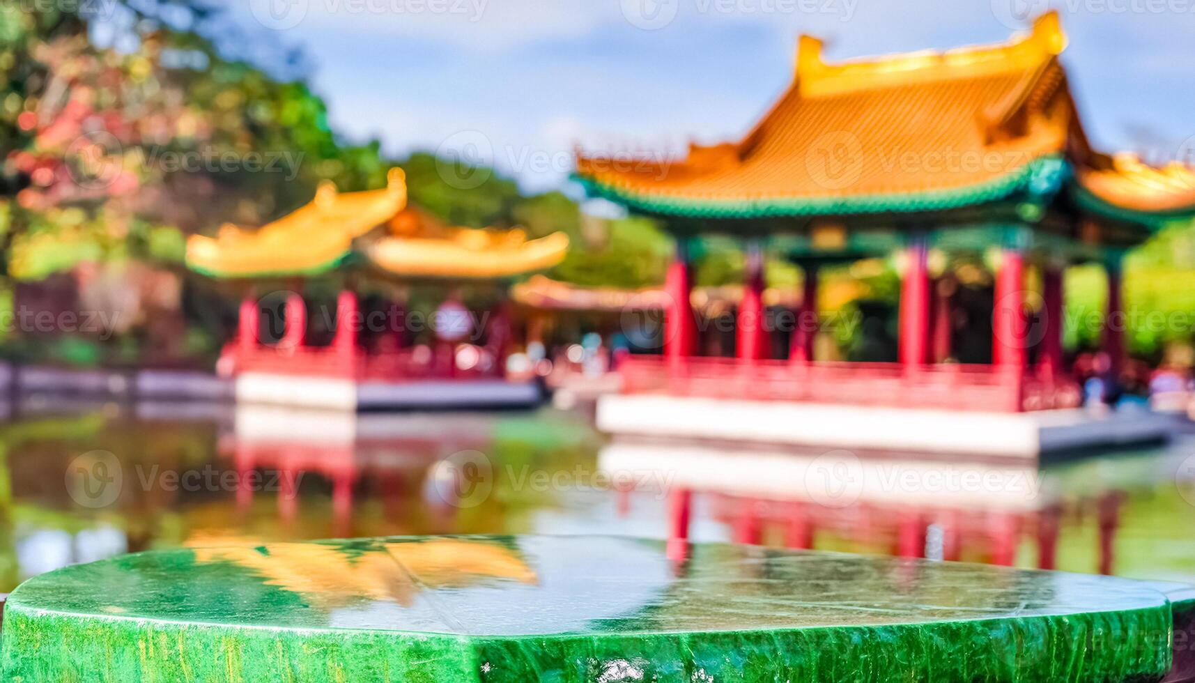 Green Jade Tabletop with Blurred Pagoda in Background photo