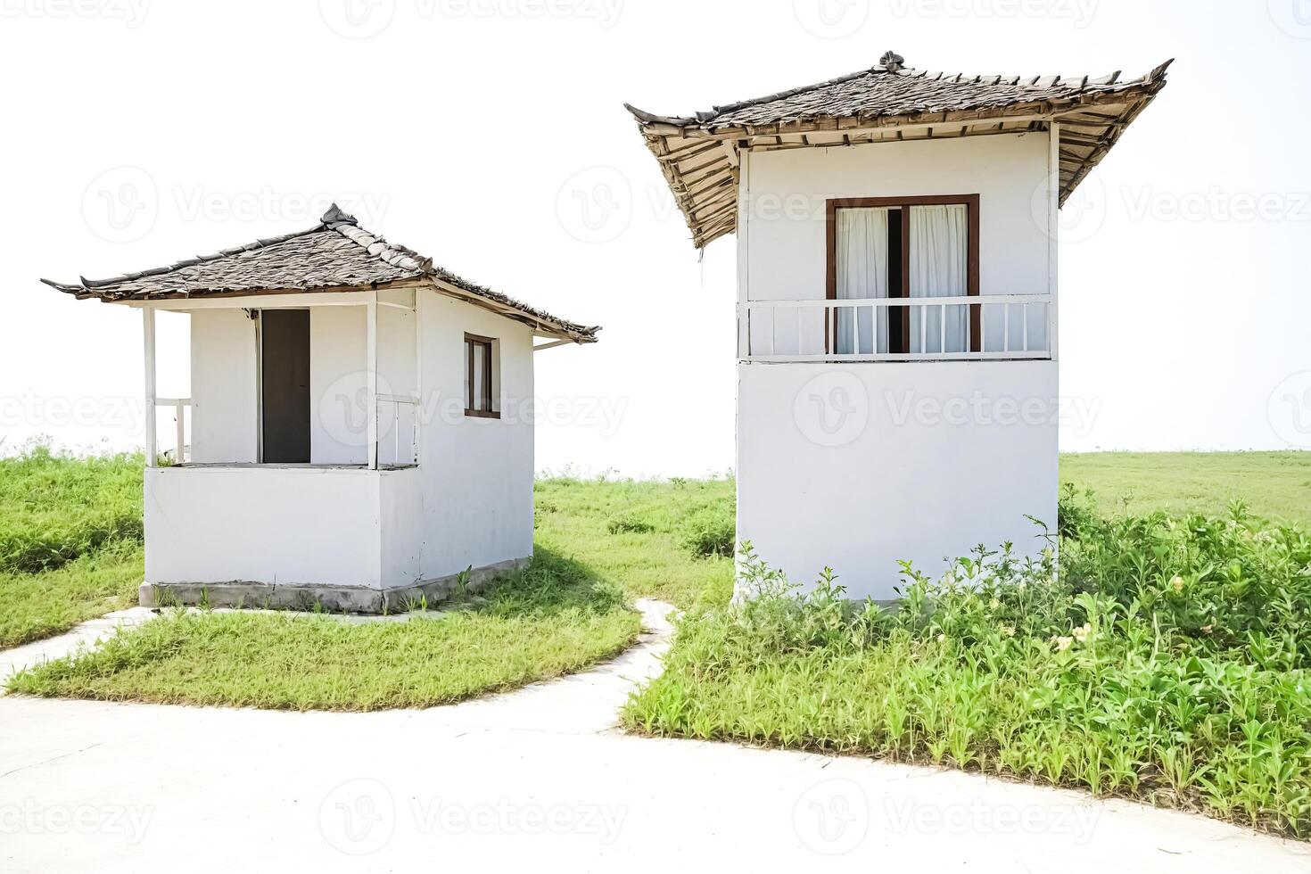 Two White Houses on a Grassy Field photo