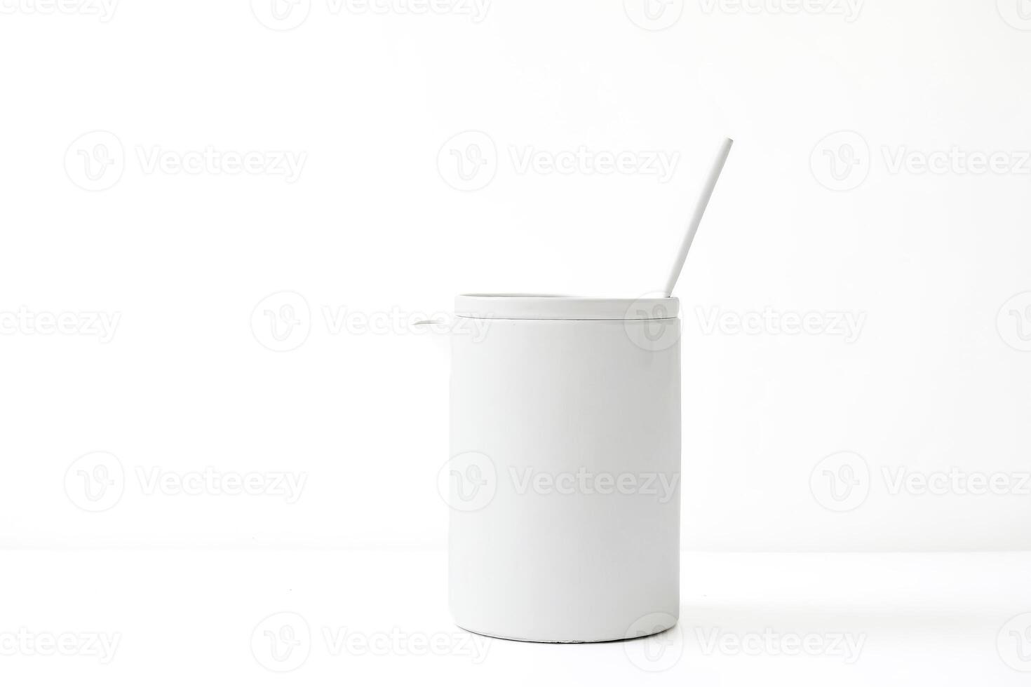 White Ceramic Jug with a Spoon on a White Background photo