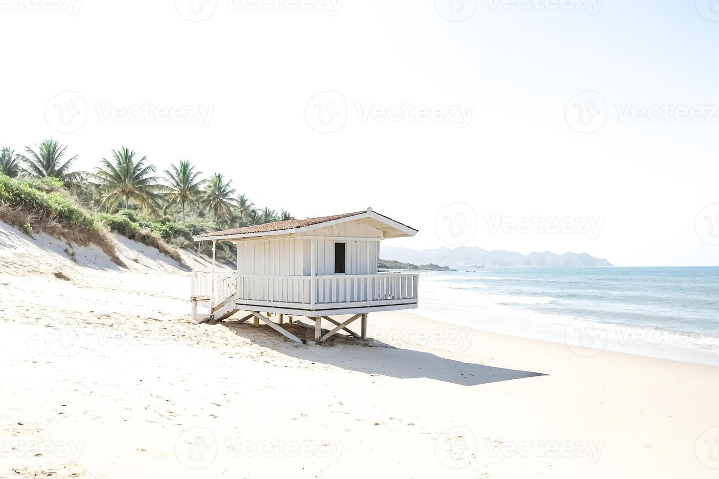White Beach House on a Sandy Shore photo