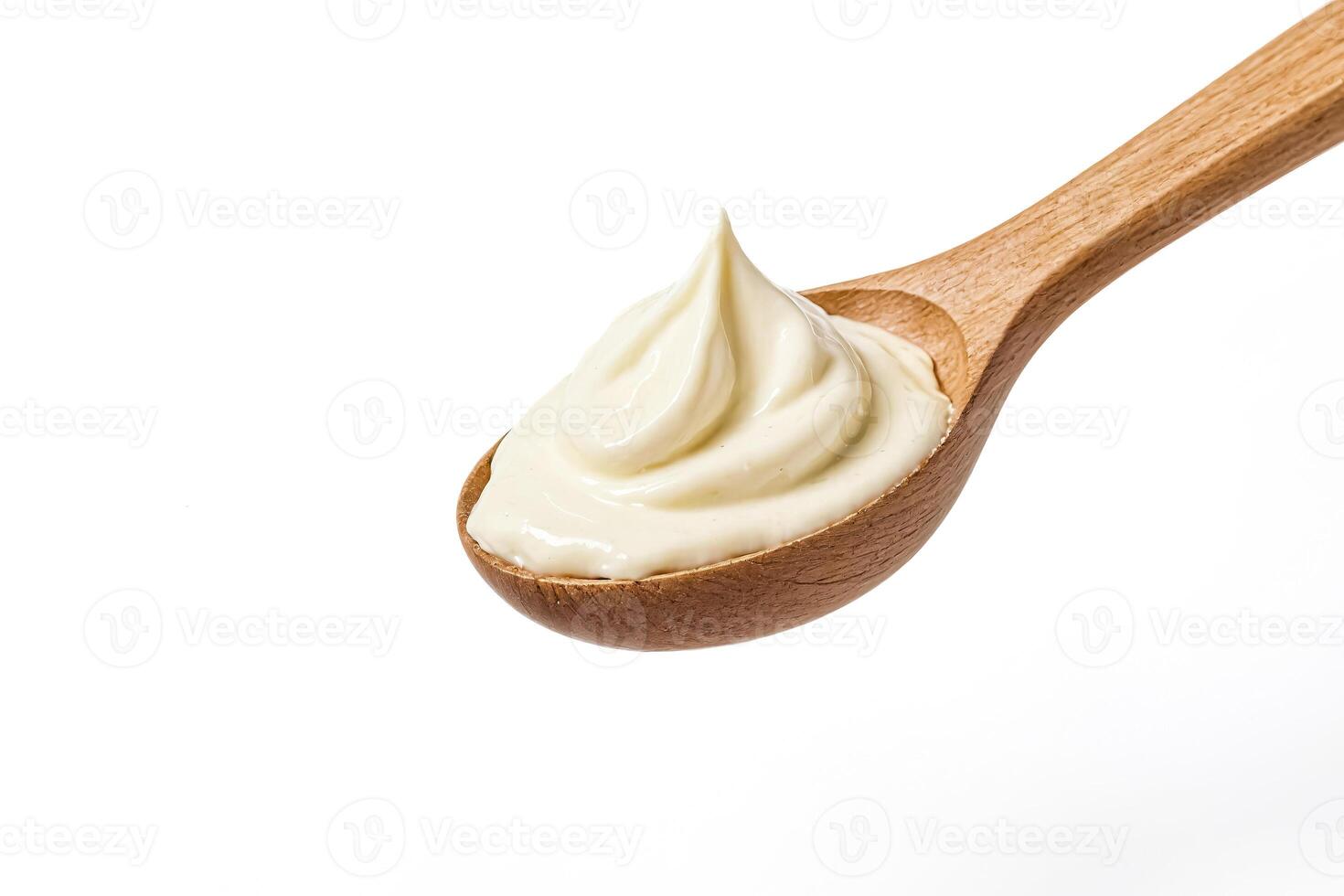Close-up of a Wooden Spoon with Creamy Mayonnaise photo