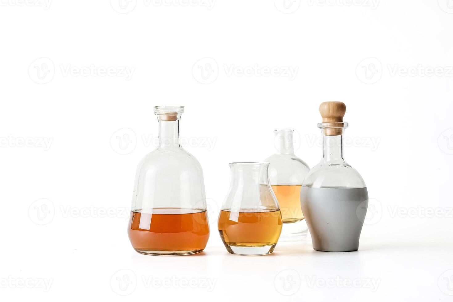 Three Glass Bottles with Liquid on White Background photo