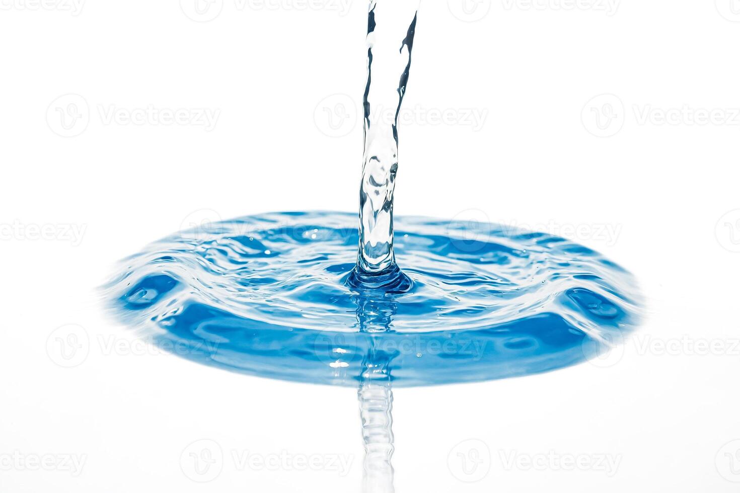 Water pouring into a pool, creating ripples photo