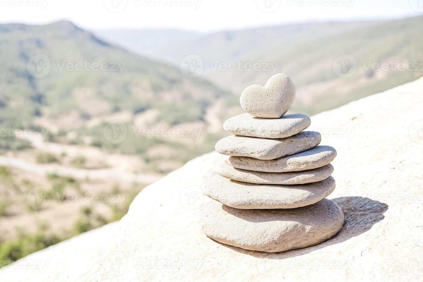 Stacked Rocks with Heart Shaped Stone on Top photo