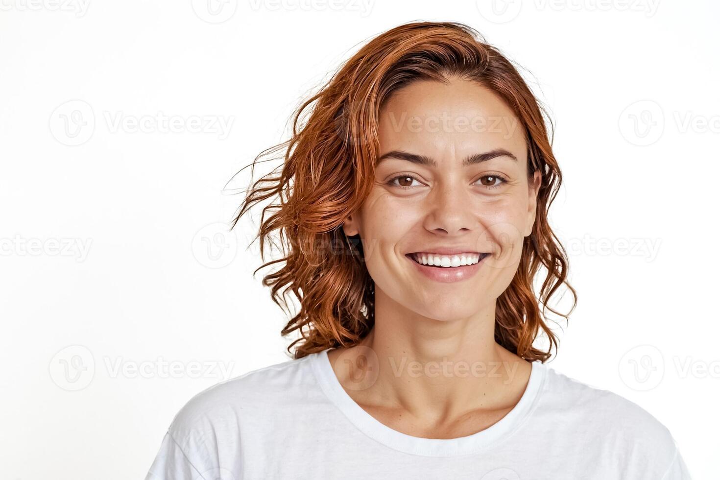Portrait of a happy woman with red hair smiling against a white background photo