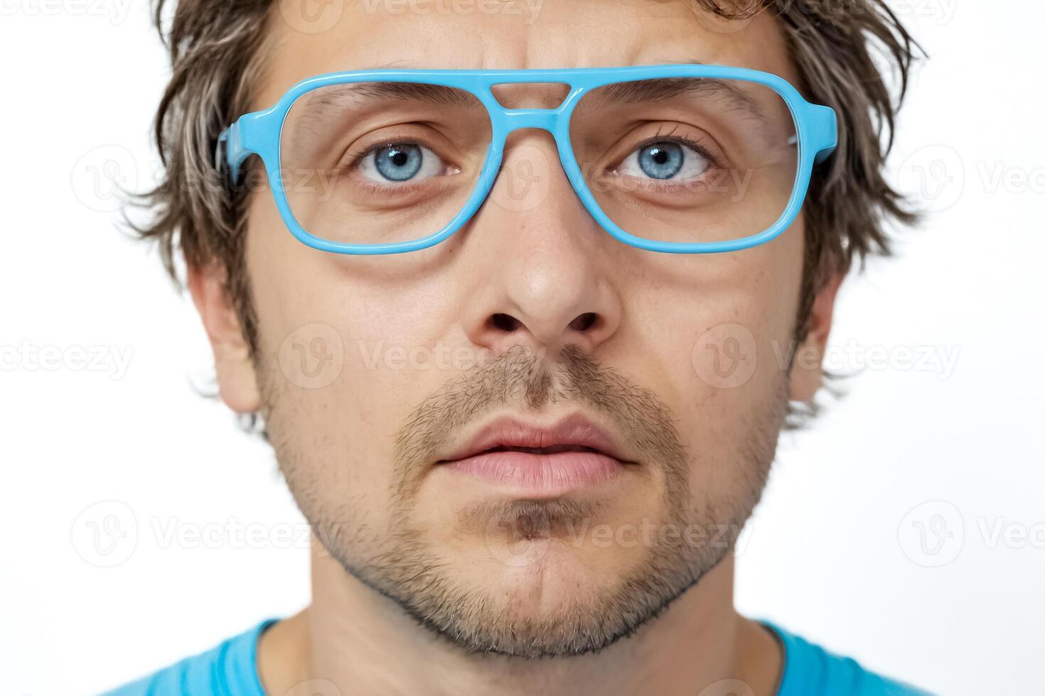 Close-up portrait of a young man wearing blue glasses photo