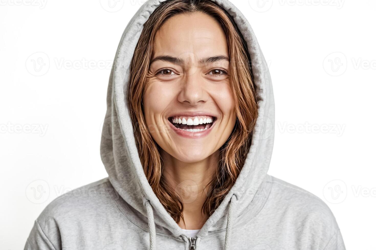 Young woman in a grey hoodie smiling photo