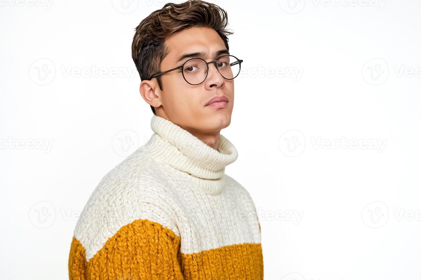 Young man in a yellow and white sweater looking away photo