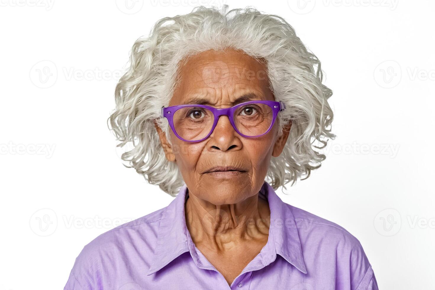 Portrait of a serious senior woman with curly gray hair and purple glasses photo