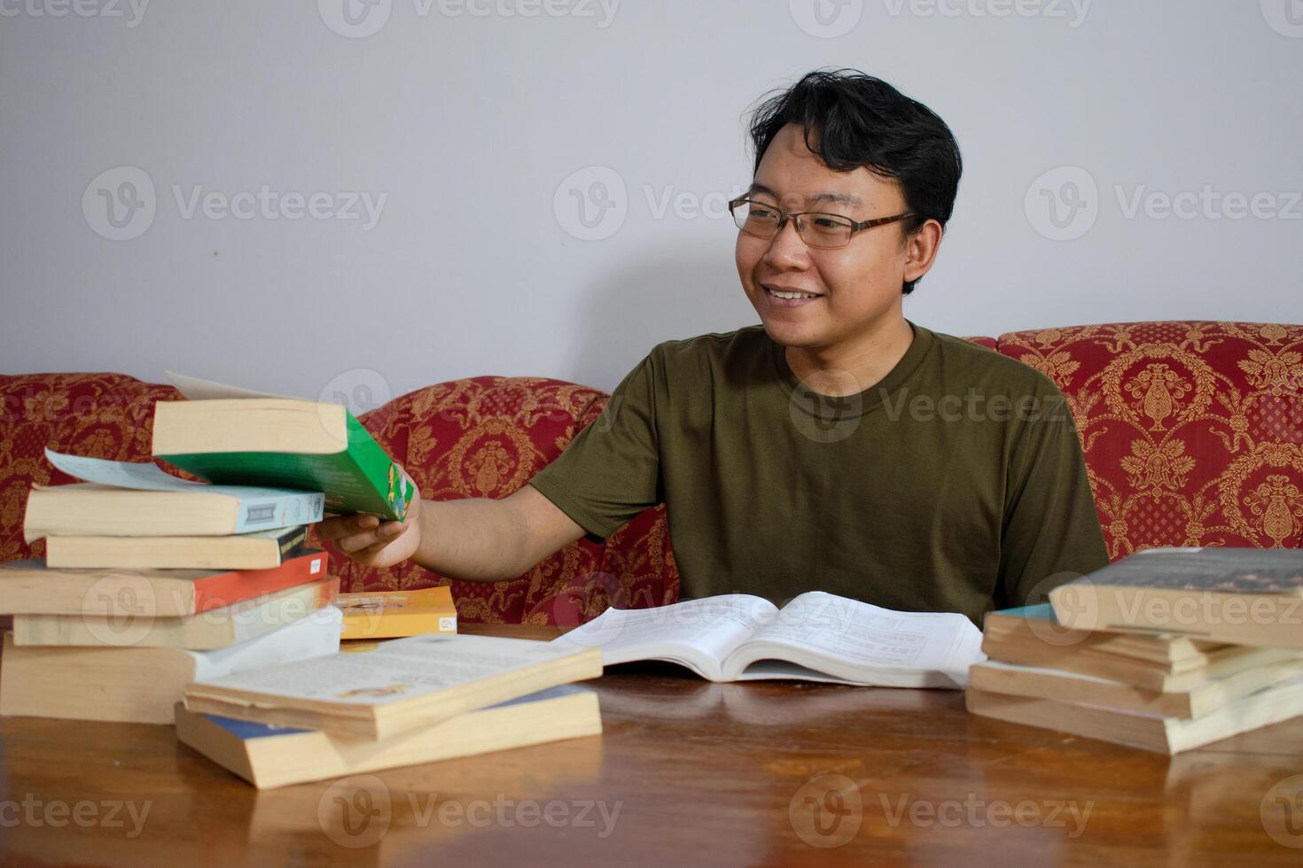 Asian young student study, reading and writing sit on sofa at living room. Isolated white background photo