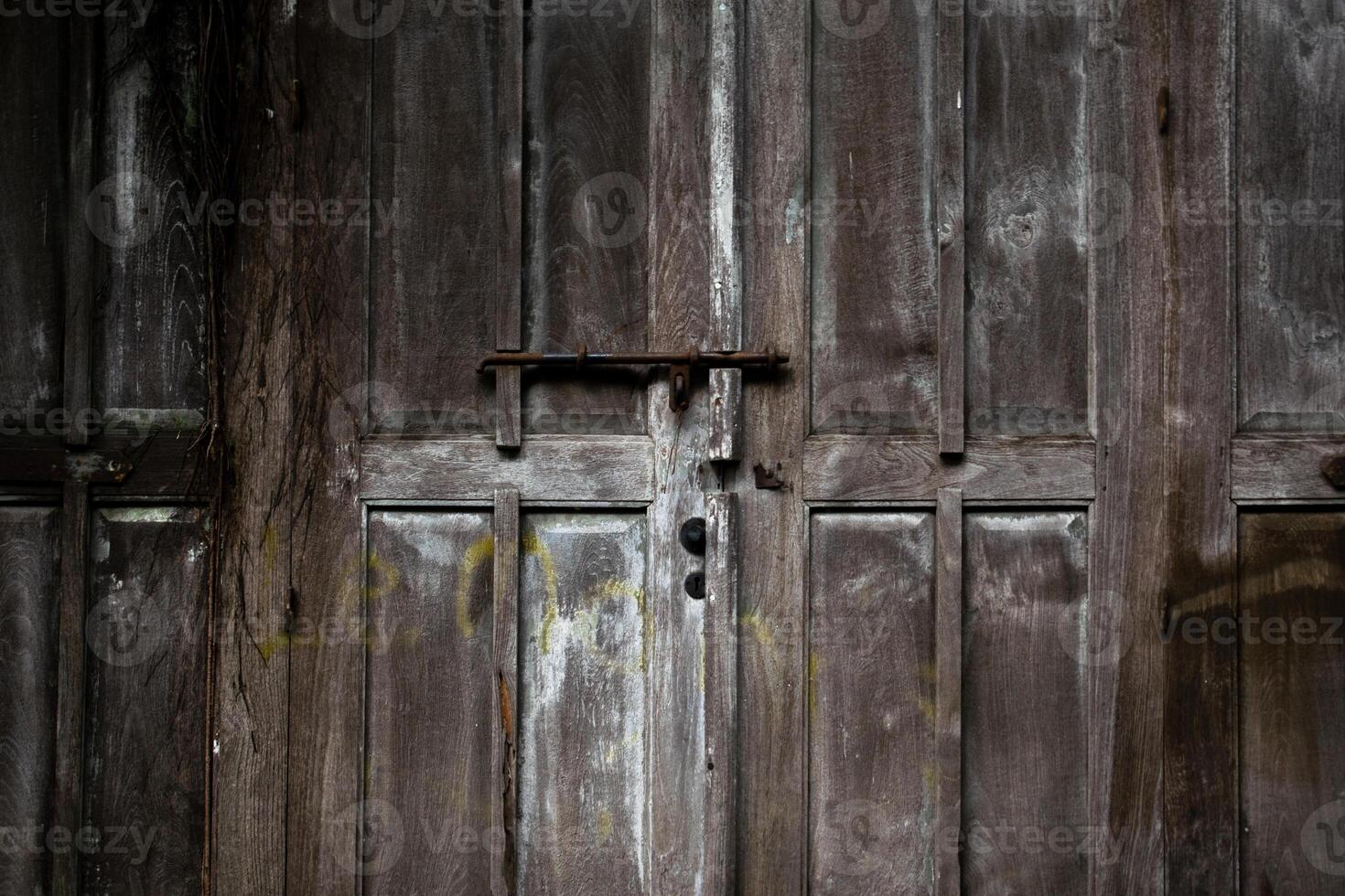 Old wooden door locked with old vintage padlock. Pattern wood background photo