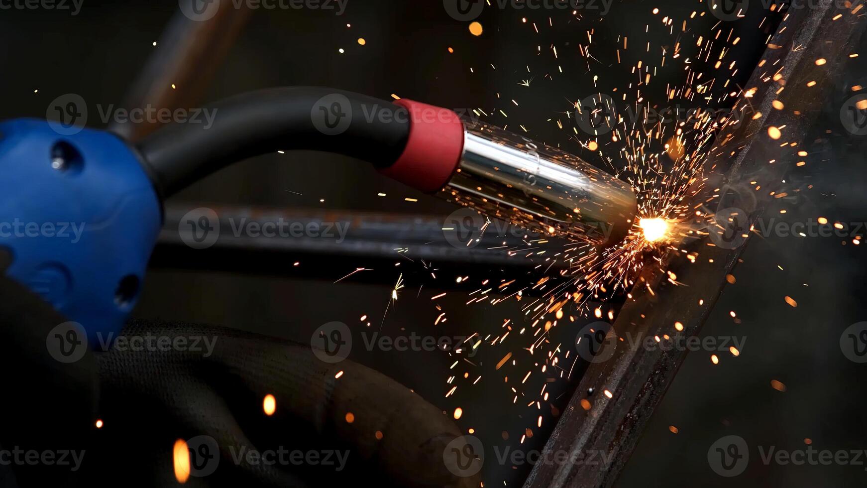 Detail of heavy industry manufacturing, sparks come out of a metal working welder. Closeup of a welding machine in work. Grinding a metal door in production. Grinding a steel structure photo
