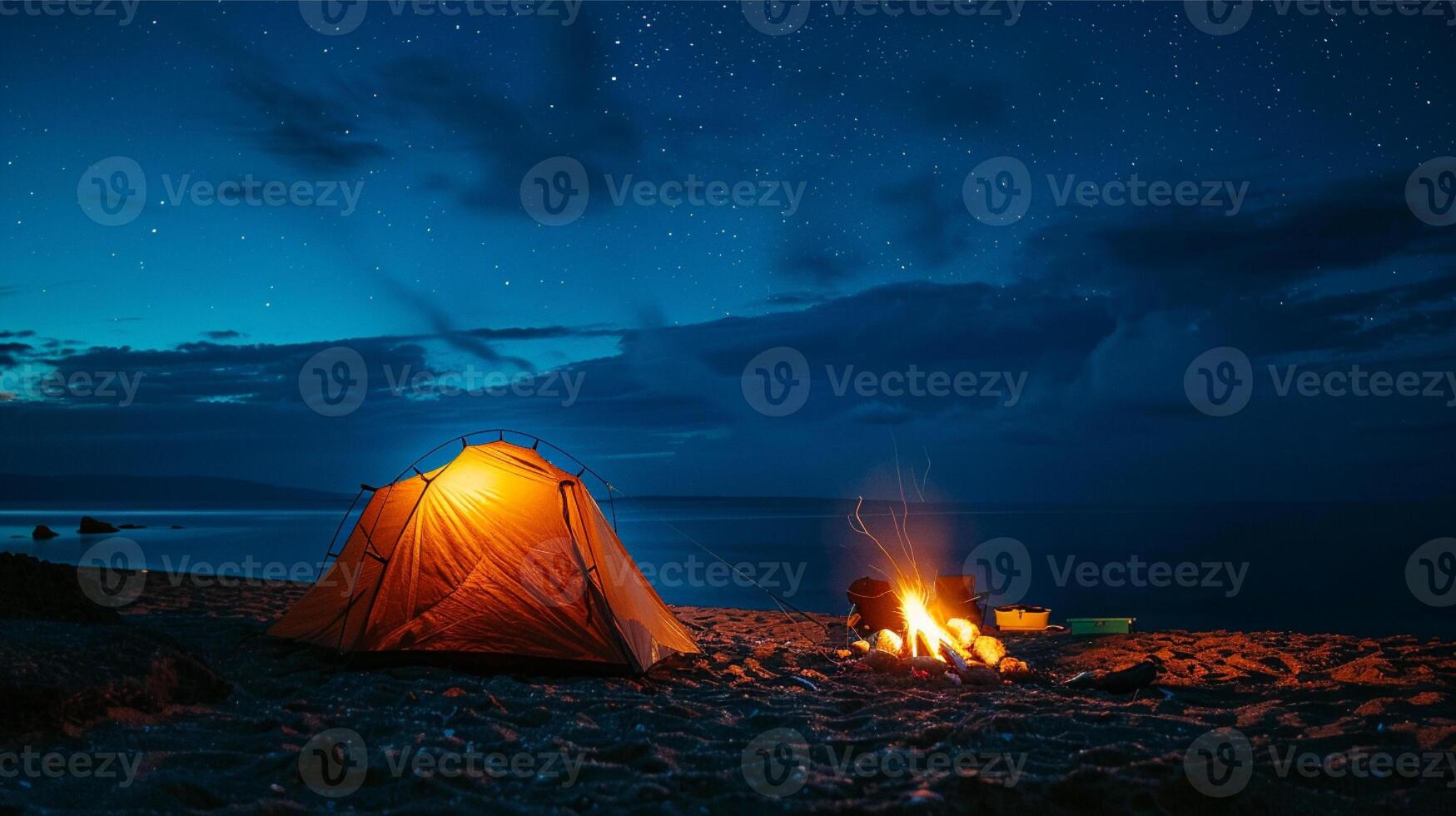 Camping on the beach at night with bonfire and tent. photo